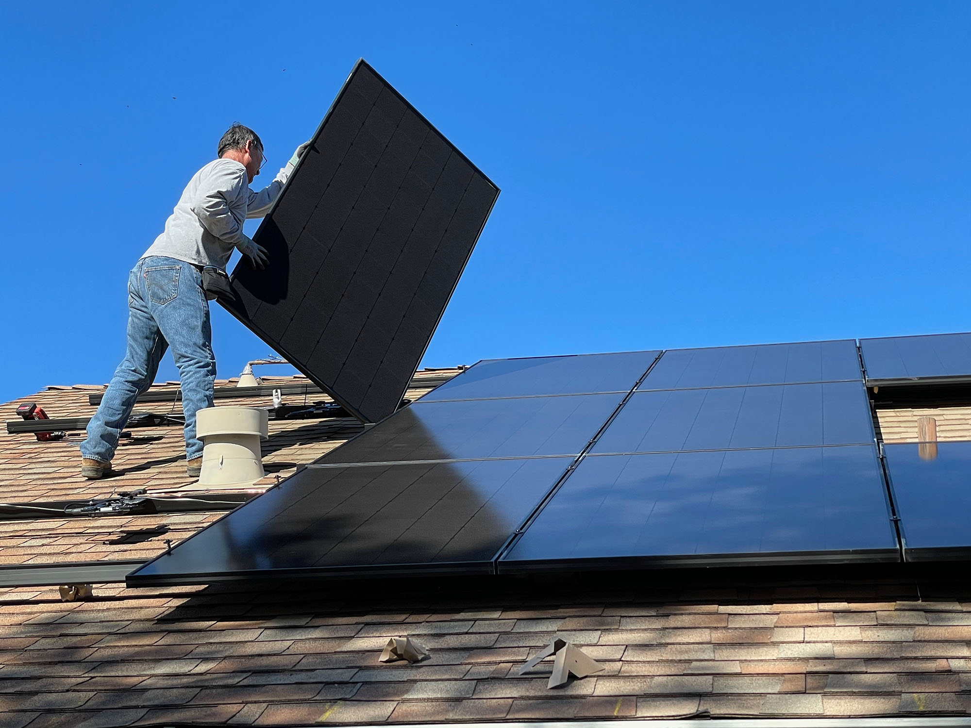 Solar panel being installed on a residential rooftop